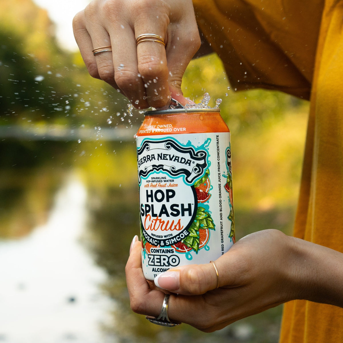 Sierra Nevada Brewing Co. Hop Splash Citrus Non-Alcoholic Sparkling Hop Water - A woman opens a cold can of Hop Splash Citrus