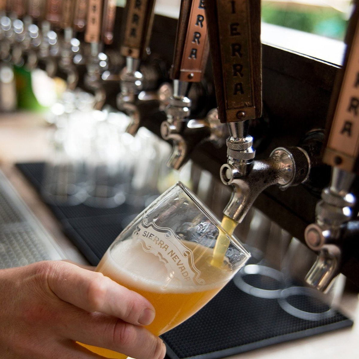 Bartender's hand pouring a Sierra Nevada beer