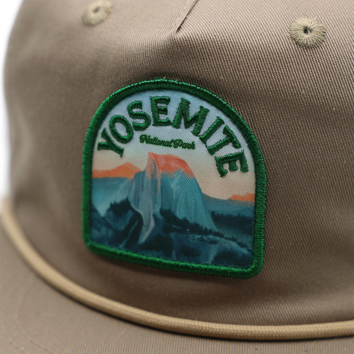 Beige cap with Yosemite National Park patch on a white background