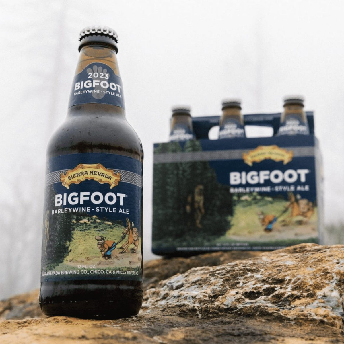 A bottle of Bigfoot sitting next to a 6-pack