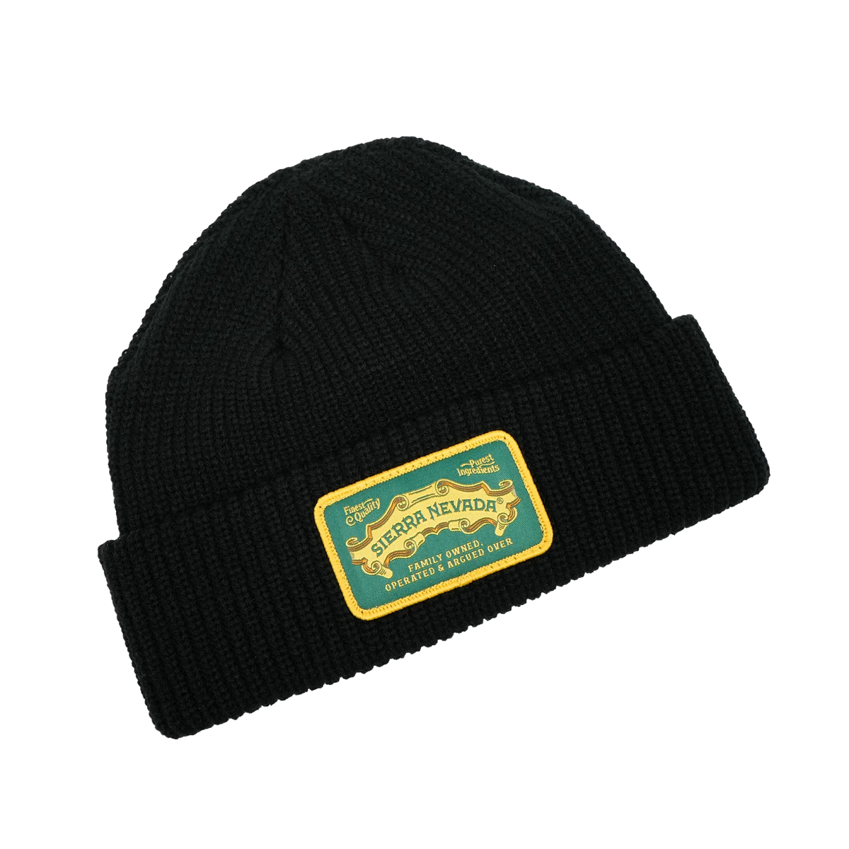 Black beanie with a gold and green label on a white background