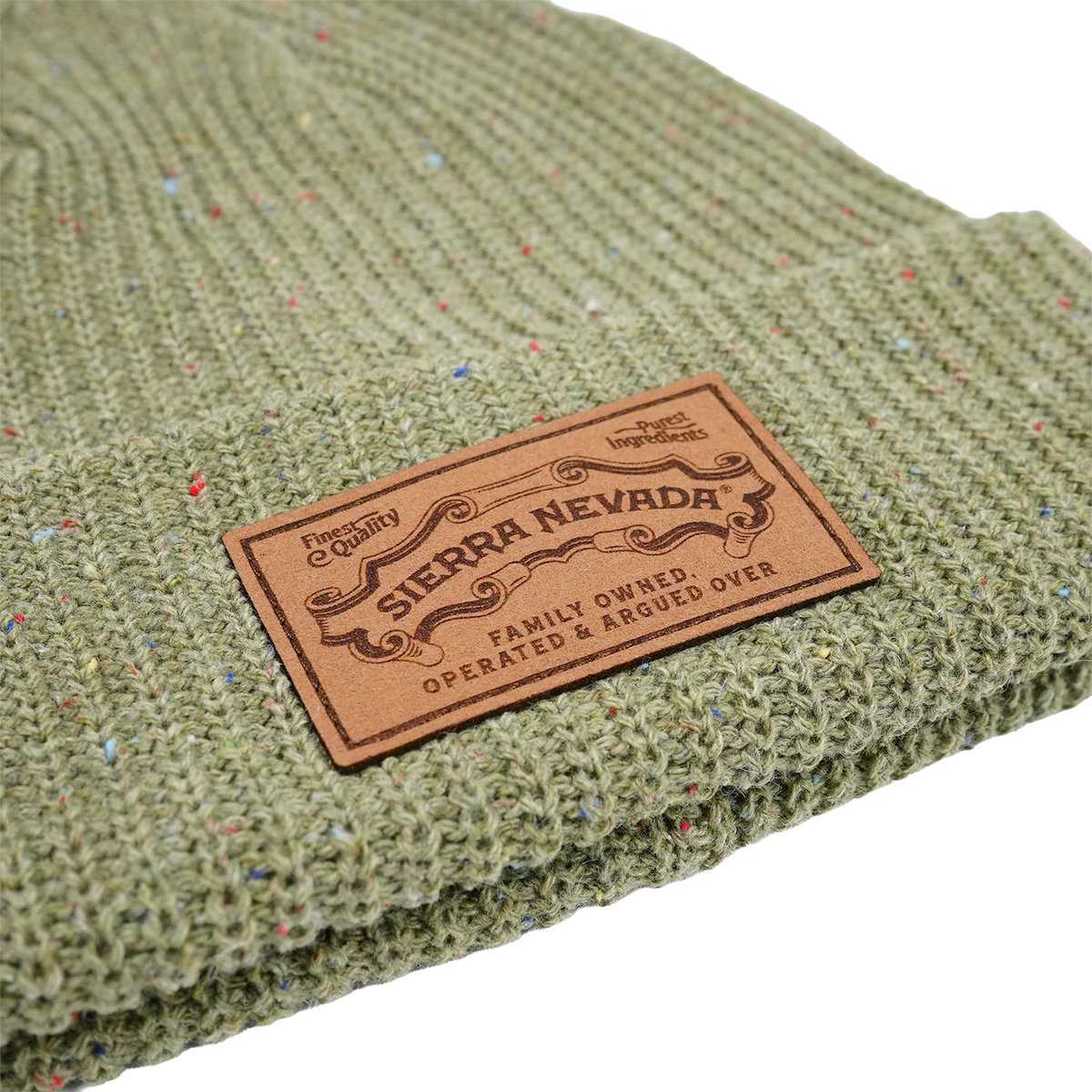 Green textured fabric with a Sierra Nevada leather label on a white background
