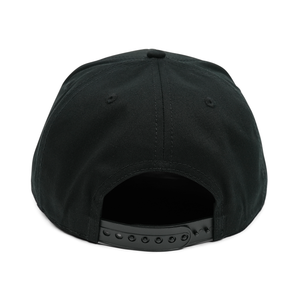 Thumbnail of Black cap with a leather brim on a white background