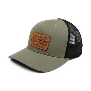 Thumbnail of Green trucker cap with a brown leather patch on a white background