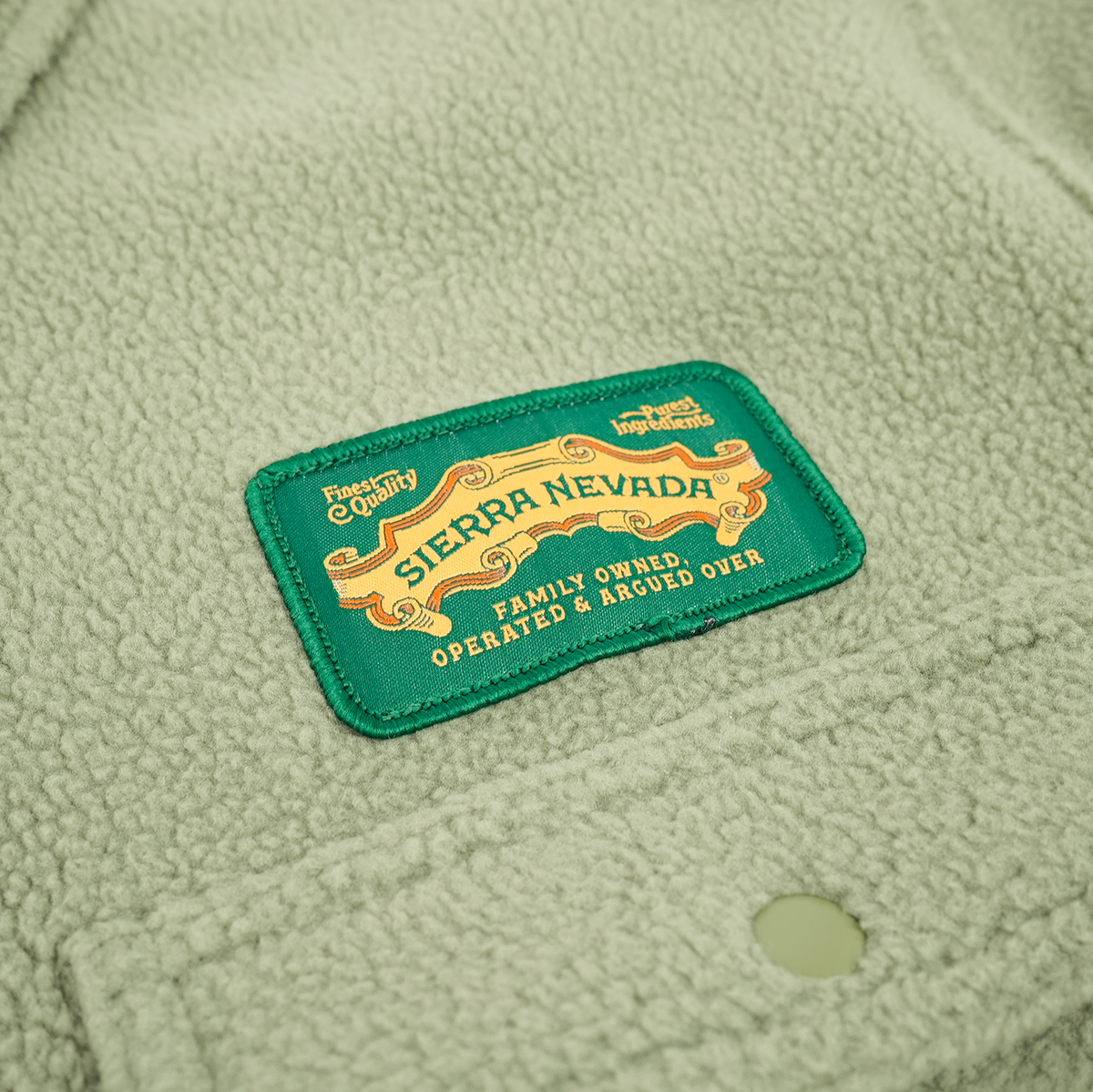 Sierra Nevada logo on a green textured fabric background
