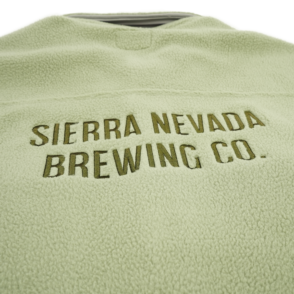 Green fleece jacket with 'Sierra Nevada Brewing Co.' branding on a white background