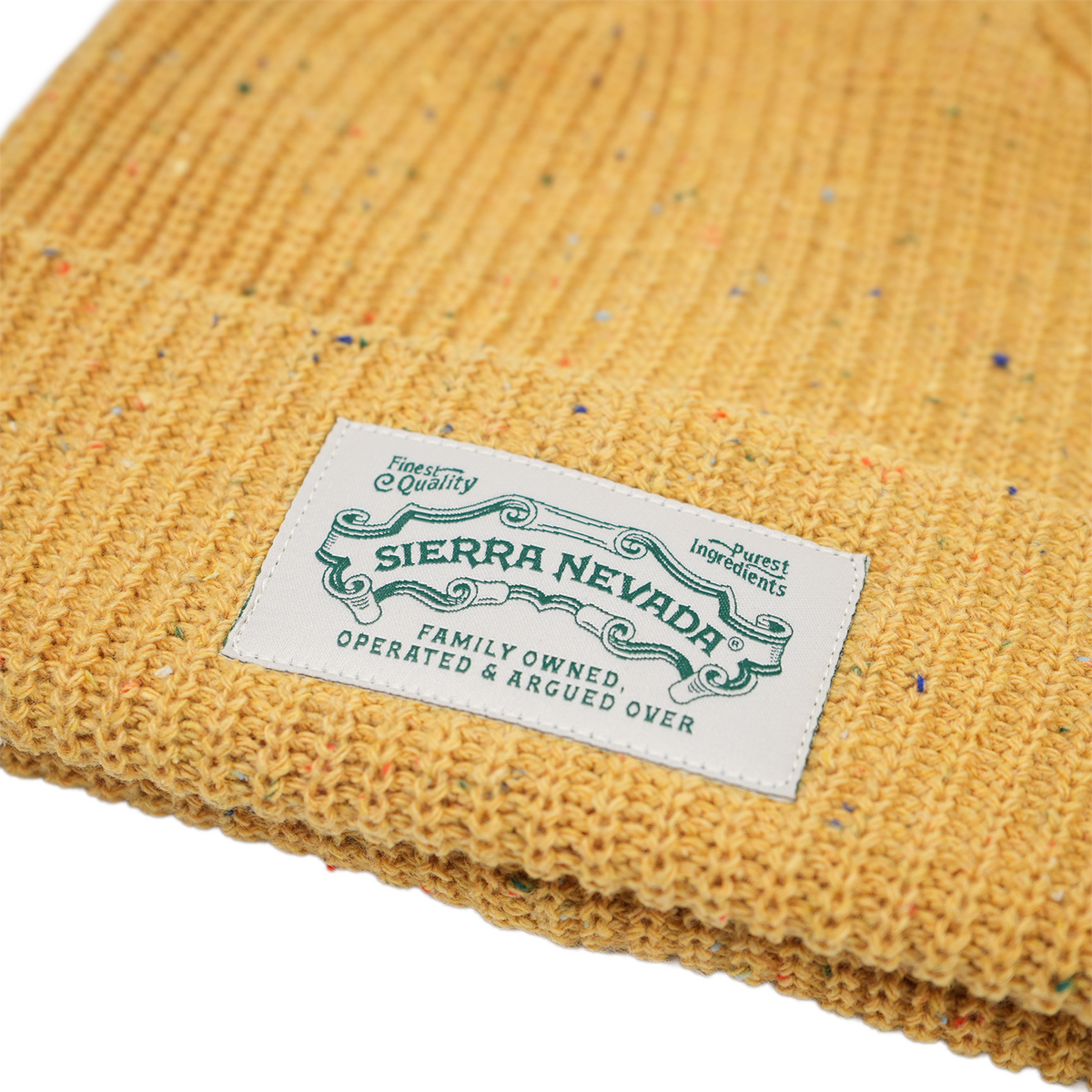 Close-up of a yellow textured fabric with a Sierra Nevada label.