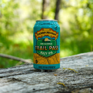 Thumbnail of Sierra Nevada Brewing Co. Trail Pass Hazy IPA can sitting on a log in the woods