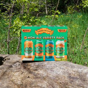 Thumbnail of Sierra Nevada Brewing Co. Trail Pass Variety Pack box sitting outside on a log in front of a wooded area