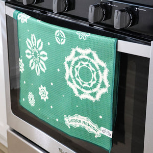 Thumbnail of Green towel with white patterns hanging on a stove