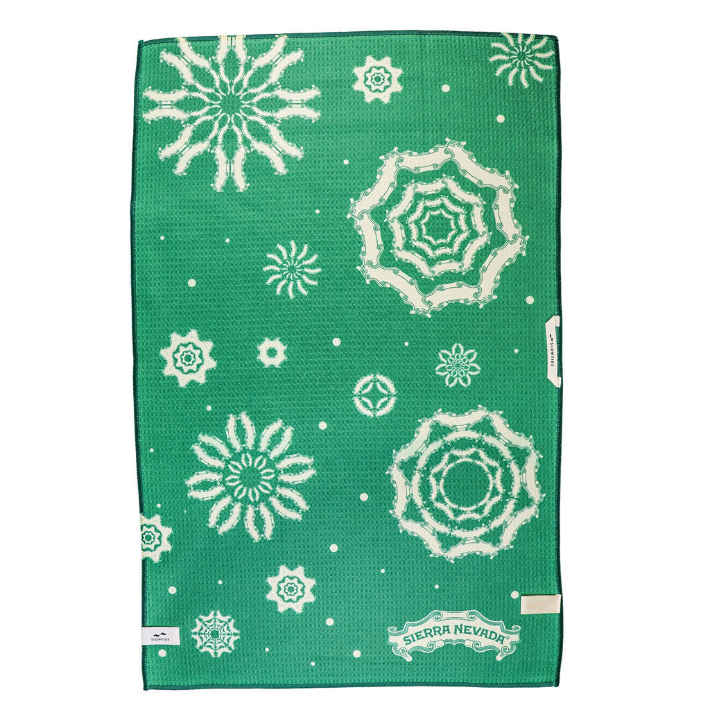 Green towel with white snowflake patterns and Sierra Nevada logo on a white background