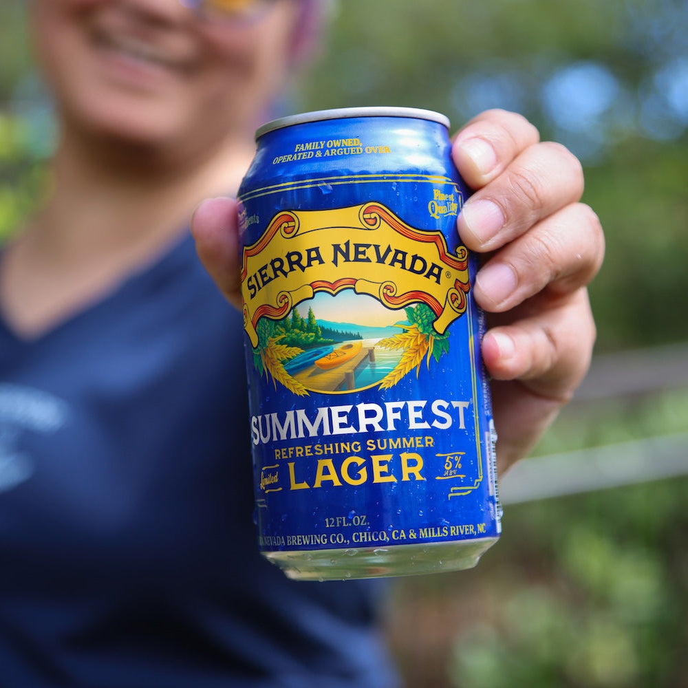A person holding a can of Sierra Nevada Summerfest Lager