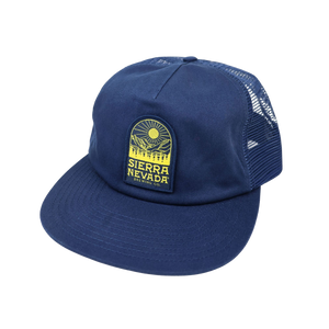 Thumbnail of A navy blue trucker hat with a yellow and black Sierra Nevada patch on the front, set against a plain white background.
