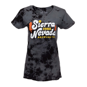 Thumbnail of A women's short-sleeve crewneck t-shirt featuring a black and dark gray tie-dye pattern. The front is printed with a large graphic reading 'Sierra Nevada 1980 Brewing Co.