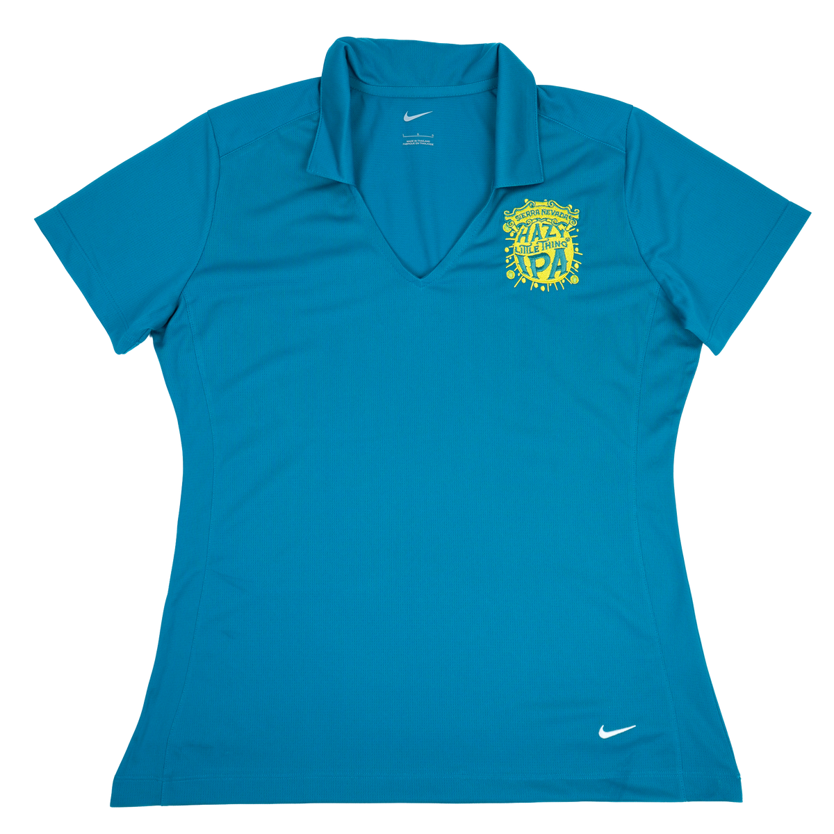 A women's short-sleeve polo shirt in bright teal blue, featuring a yellow and white crest on the left chest and a small white Nike swoosh on the lower right hem.