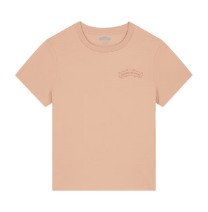 Thumbnail of A light peach-pink short-sleeve crewneck t-shirt with a subtle tonal graphic on the left chest, displayed flat against a solid white background.