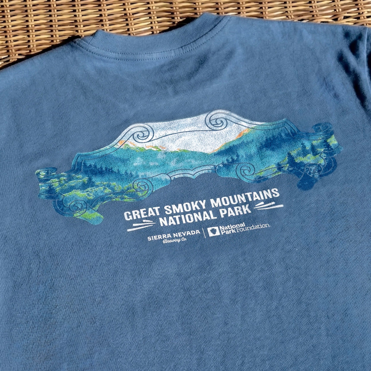Blue t-shirt with Great Smoky Mountains National Park graphic on a woven surface
