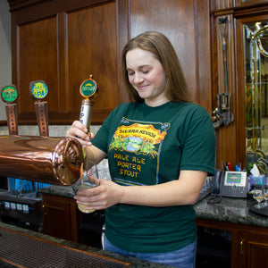 Thumbnail of Sierra Nevada Pale Ale - Porter - Stout short sleeve green t-shirt worn by a woman in a brewery filling a pint glass from the tap