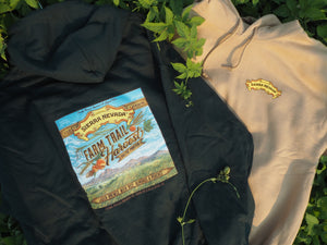 Thumbnail of Sierra Oro Farm Trail Green and Gold sweatshirts on a green bush