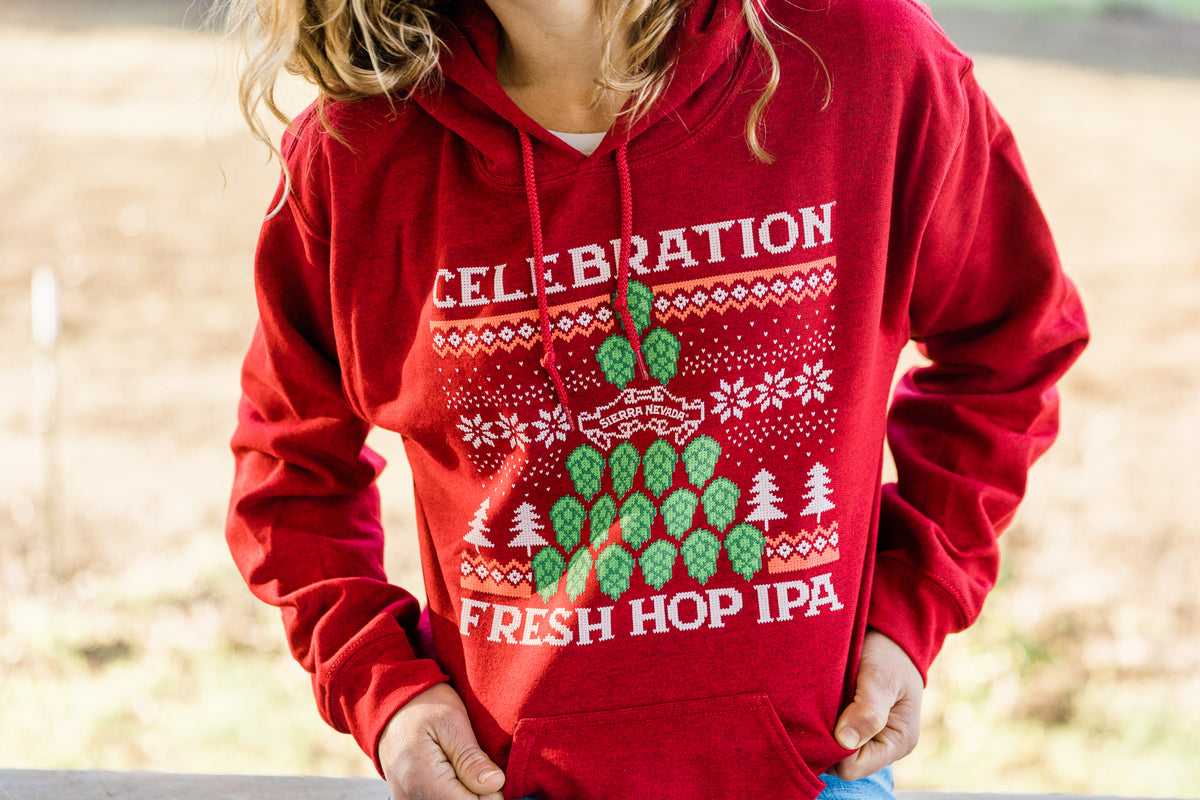 Celebration IPA Holiday Hooded Sweatshirt - front view worn on woman outdoors