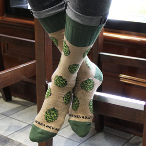 Thumbnail of Sierra Nevada Brewing Co. Hop Socks featuring hop pattern worn by a person sitting at a bar