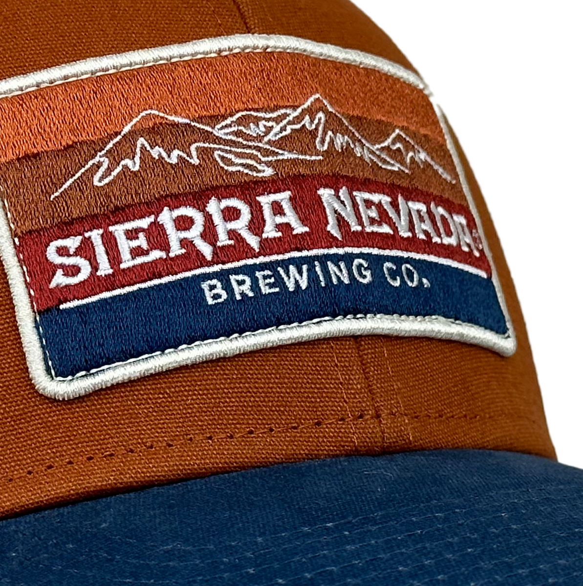 Detail view of the custom patch on Sierra Nevada's Rusty Mountain Gradient Trucker Hat